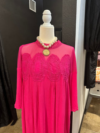 Hot pink maxi dress with sheer mesh yoke, lace appliqué detail, long sleeves, and flowing silhouette.
