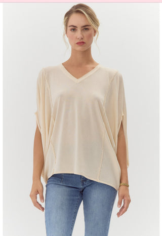 Solid loose fit tunic top with V-neck, half draped sleeves, and out-line stitch detail.