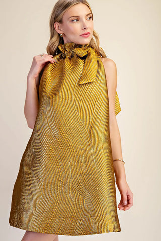 Gold metallic textured jacquard mini dress with ruffle tie neck detail and sleeveless silhouette.