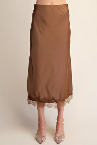 Brown satin midi skirt with matching lace trim hem detail, styled with crystal embellished heels.