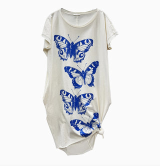 Cream short-sleeve t-shirt dress featuring four blue butterfly prints arranged vertically, with side knot detail.