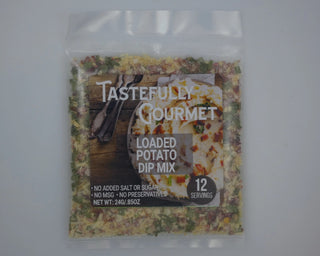 Clear packet of Tastefully Gourmet Loaded Potato Dip Mix containing visible green herb and cheese seasonings, 12 servings.