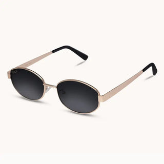 Mia sunglasses with gold oval metal frames, dark black lenses, and black rubber temple tips.