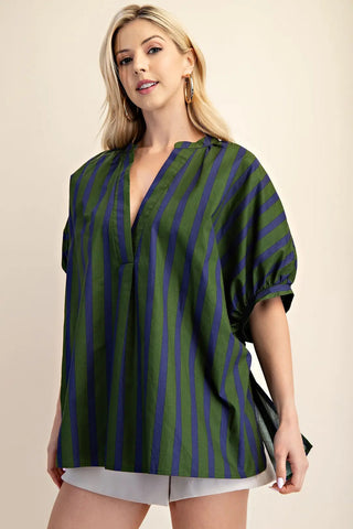 Oversized green and navy vertical stripe v-neck placket top with short rolled sleeves on blonde model.