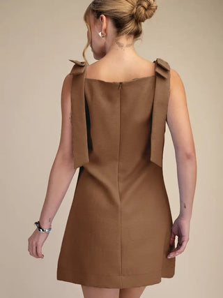 Camel brown textured mini dress with bow shoulder straps and back zipper closure, A-line silhouette.