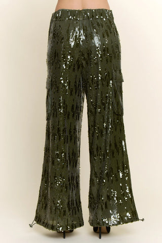 Olive green wide-leg sequin cargo pants with silver sequins, elastic waistband, and side cargo pockets.