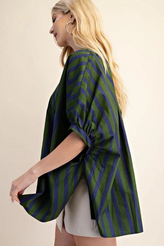 Oversized green and navy striped v-neck top with puffed elbow sleeves and side slits.