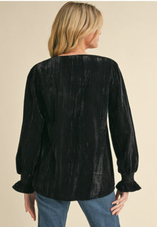 Glossy velvet top with V-neck and long poet sleeves.
