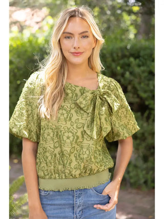 Olive green burnout floral top with large front bow, puff sleeves, and ribbed hem waistband.