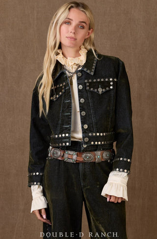 Dark denim cropped jacket with silver stud embellishments, worn over cream ruffled blouse with concho belt.