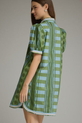 Green and blue geometric printed mini dress with short puff sleeves and collar detail, shown from back.