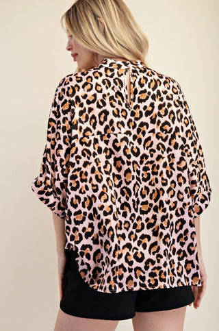 Pink leopard print mock neck oversized top with rolled sleeves, shown from the back view.