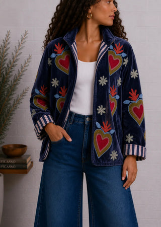 Navy blue velvet jacket with embroidered red hearts, floral motifs, and striped cuff and collar trim.