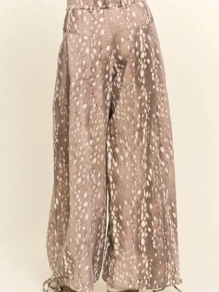 Taupe wide-leg corduroy pants featuring an all-over white fawn spot print and tie hem details.