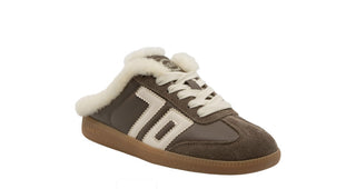 Taupe suede slip-on sneaker mule with cream shearling lining, white laces, side stripe detail, and gum sole.