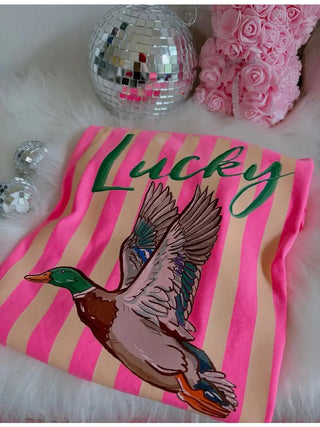 Neon pink striped t-shirt with "Lucky" script and flying mallard duck graphic, displayed flat.