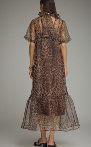 Brown leopard print sheer midi dress with short sleeves, ruffled hem, and back neck scarf tie detail.