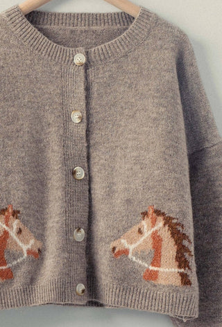 Taupe knit cardigan with horse head intarsia graphics, pearl buttons, and ribbed trim detailing.