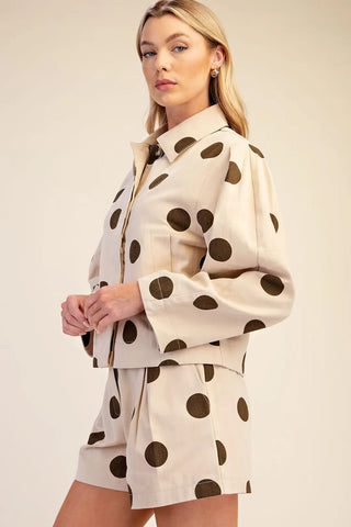 Cream and olive polka dot cropped jacket with collar neck, long sleeves, and front pocket detail.