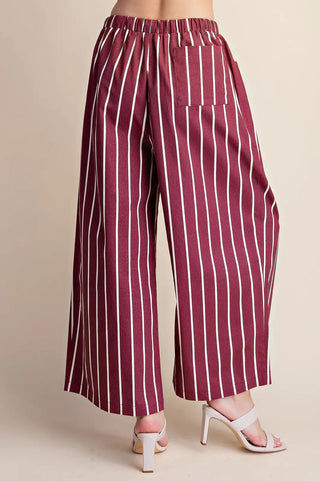 Burgundy and white striped wide-leg pants with elastic waistband and back patch pocket, shown from behind.
