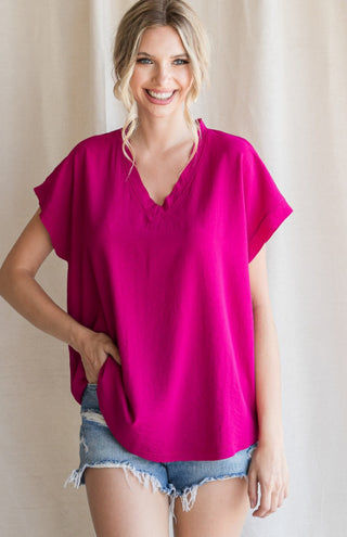Solid top with short cap sleeves and raw edge hems