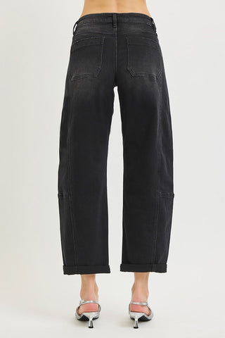 Black high rise crop barrel jeans with cuffed hem, wide leg, patch detailing, worn with silver heels.
