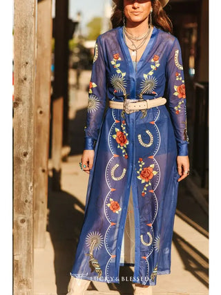 Denim blue sheer mesh maxi duster with floral roses, horseshoes, and Western-inspired prints, belted at waist.