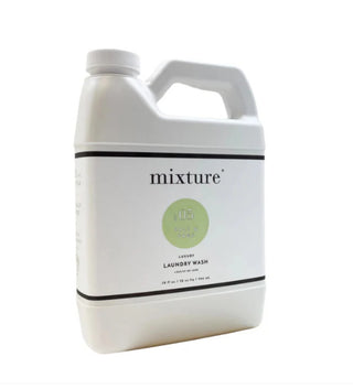 White 64 oz jug of Mixture Luxury Laundry Wash No. 05 Salt & Sage with green label accent.