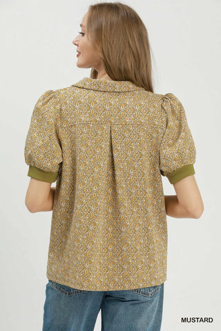 Mustard yellow printed collared puff sleeve top with olive green ribbed cuffs, shown from back view.