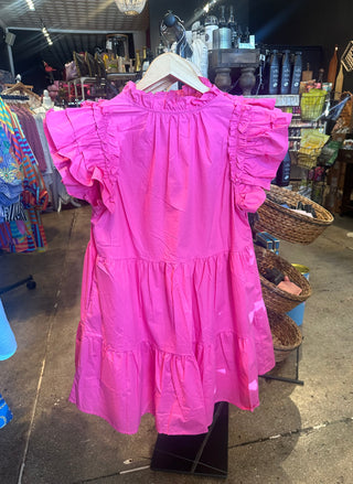 Bright pink tiered ruffle-sleeve mini dress displayed on hanger in boutique shop setting.