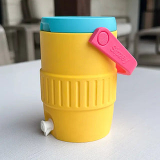 Yellow retro mini jug cooler can holder with teal lid, pink handle, and small spigot.
