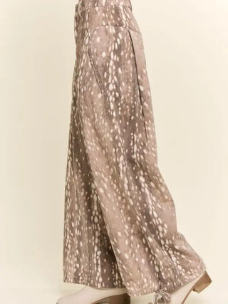 Taupe wide-leg corduroy pants featuring fawn spot print, side pocket, and tie hem detail.