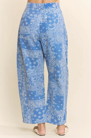 Blue and white paisley bandana print high-rise barrel leg pants with wide-leg silhouette, back view.