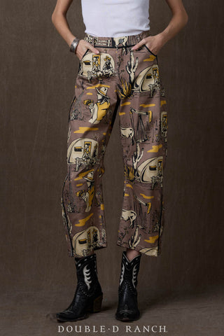 Wide-leg brown barrel pants with western oil camp print, worn with black cowboy boots.