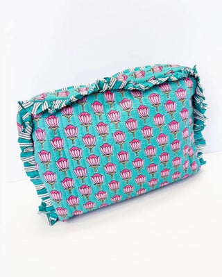Quilted teal cosmetic bag with pink floral print and ruffled striped trim edges.