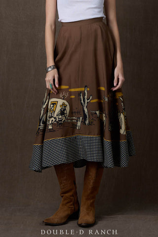 Brown midi skirt with western cowboy novelty print border, gingham trim, paired with tan cowboy boots.