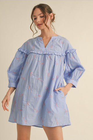 Blue and white striped mini dress with pink ribbon embroidery, ruffle yoke, split neckline, and puff sleeves.