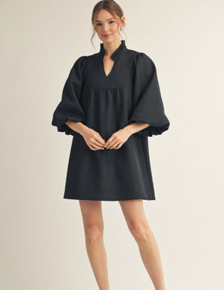 Black babydoll mini dress with voluminous 3/4 balloon sleeves, ruffled neckline, and empire waist.