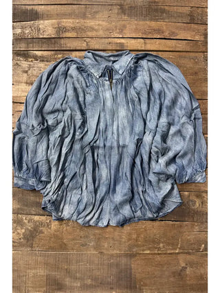 Willow Sky Top in washed blue denim with billowy sleeves, gathered neckline, and zip closure.
