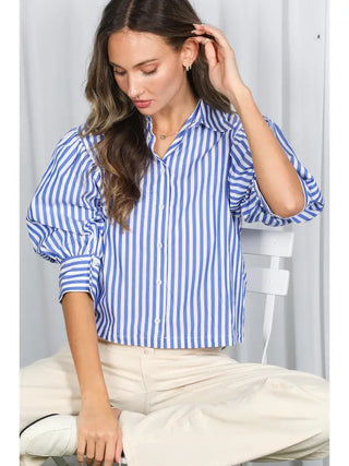 Blue and white striped button-down blouse with short puff sleeves and cropped length on model.
