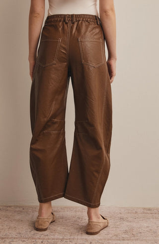 Brown faux leather wide-leg pants with contrast stitching, back patch pockets, and elastic waistband, back view.