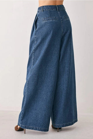 Medium wash blue denim wide leg palazzo pants with back patch pockets and high waist fit.