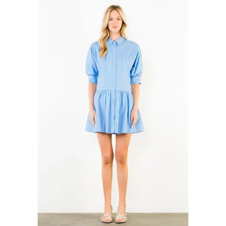 Light blue short puff sleeve collared shirt dress with drop waist and button front detail.