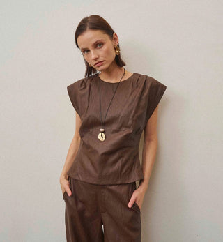Chocolate brown vegan leather sleeveless top with structured shoulders, fitted silhouette, and crew neckline.