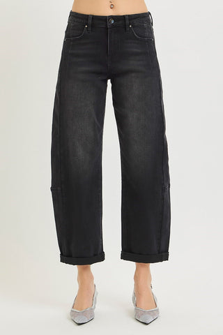 Black high rise crop barrel jeans with cuffed hem, worn with silver rhinestone heels, front view.