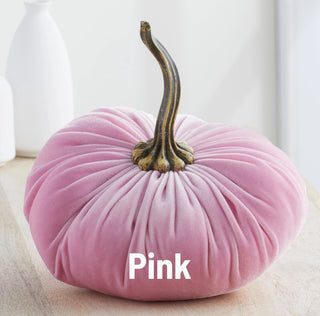 Extra large pink velvet pumpkin decoration with a rustic bronze stem on a wooden surface.