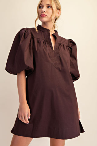 Dark brown mini dress with mandarin collar, V-neckline, and voluminous puff bubble sleeves on blonde model.