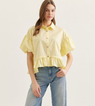 Solid short puff sleeve top featuring ruffle hem detail