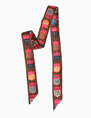 Brown satin twilly scarf featuring colorful rodeo back number patches with text like "Rodeo," "Finals," and "Round Up."