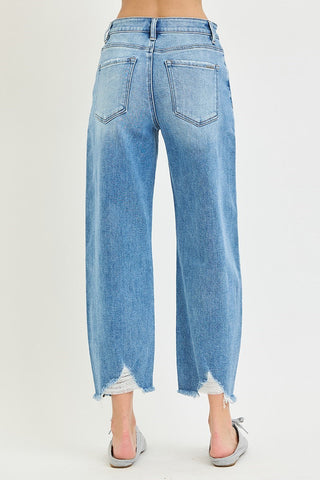Light blue wash slouchy crop barrel jeans with distressed frayed hem, shown from back view.